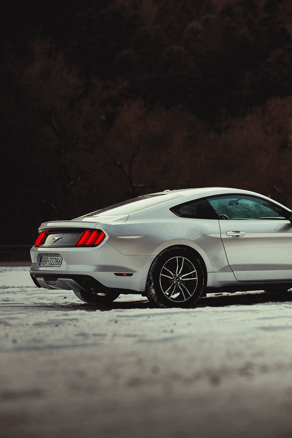 White Mustang sports car in snowy weather, from collection - automotive.